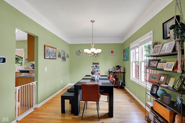 8030 Parcrest Ct, Indianapolis, IN 46259 - dining space with a chandelier, light wood-style flooring, and ornamental molding