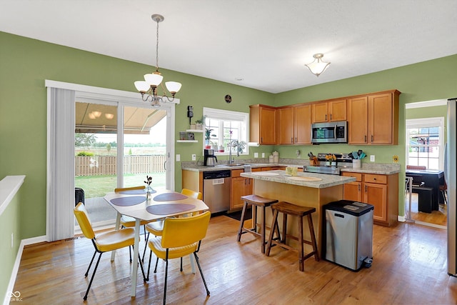 8030 Parcrest Ct, Indianapolis, IN 46259 - kitchen with stainless steel appliances, light countertops, a kitchen island, and healthy amount of natural light