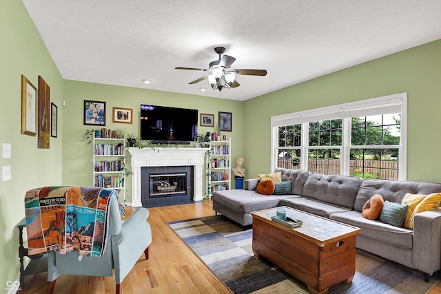 8030 Parcrest Ct, Indianapolis, IN 46259 - living room with ceiling fan, wood finished floors, and a tile fireplace