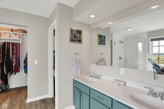 8030 Parcrest Ct, Indianapolis, IN 46259 - full bath featuring double vanity, a shower stall, wood finished floors, and a walk in closet