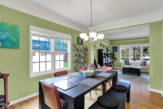 8030 Parcrest Ct, Indianapolis, IN 46259 - dining space with a chandelier, ornamental molding, and light wood-style flooring