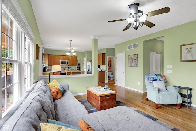 8030 Parcrest Ct, Indianapolis, IN 46259 - living area with light wood-style flooring, a chandelier, and ceiling fan