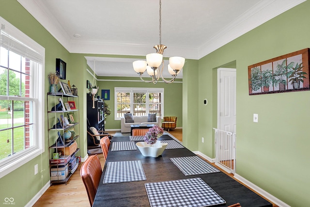 8030 Parcrest Ct, Indianapolis, IN 46259 - dining room with a chandelier, healthy amount of natural light, crown molding, and wood finished floors