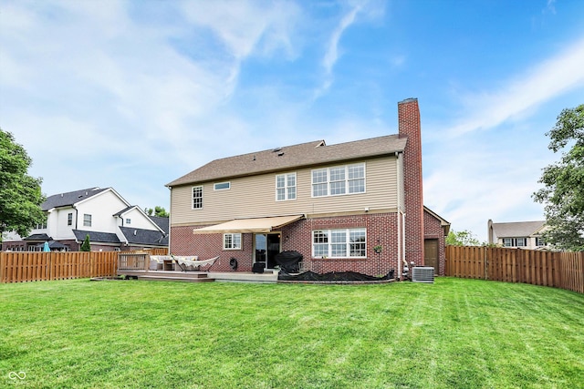 8030 Parcrest Ct, Indianapolis, IN 46259 - rear view of house featuring a chimney, a fenced backyard, a deck, and brick siding
