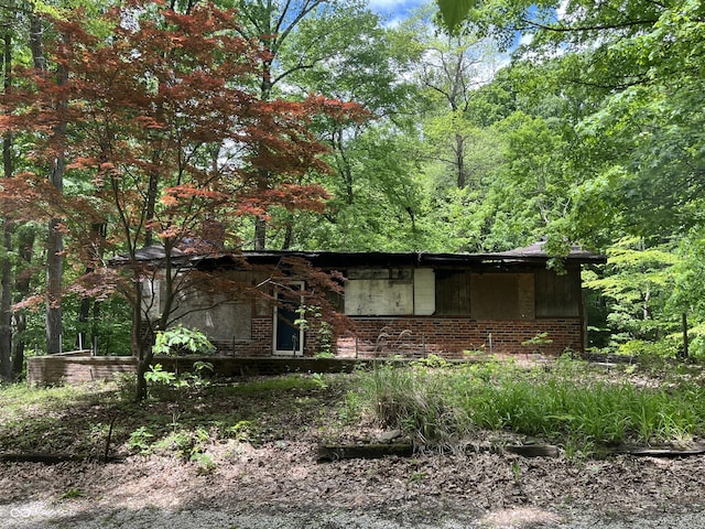 11124 S County Road 225 W, Cloverdale, IN 46120 - view of side of property with brick siding and a forest view