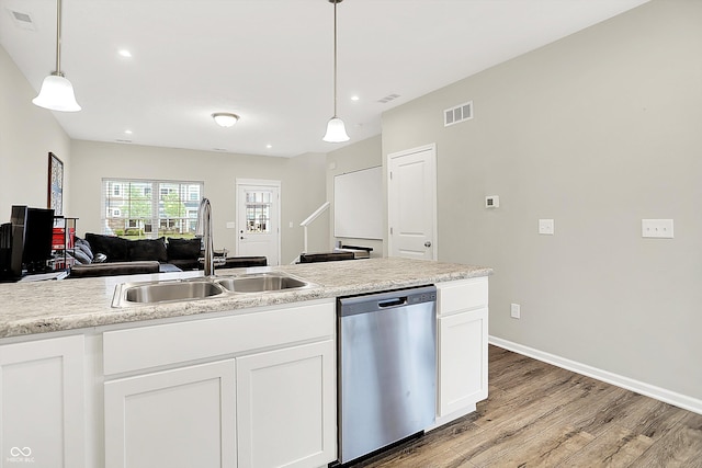 3428 Thomas Jefferson St, Westfield, IN 46074 - kitchen with stainless steel dishwasher, a sink, light wood finished floors, white cabinetry, and decorative light fixtures