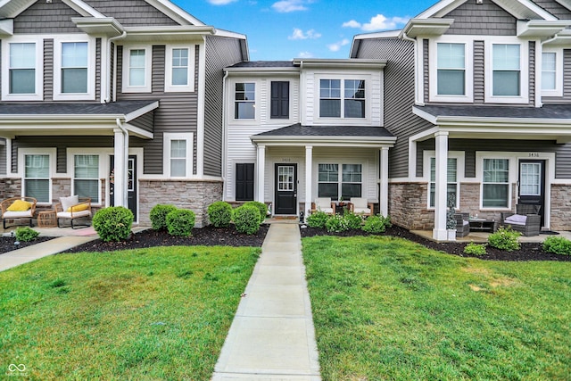 3428 Thomas Jefferson St, Westfield, IN 46074 - townhome / multi-family property with a porch, stone siding, and a front lawn
