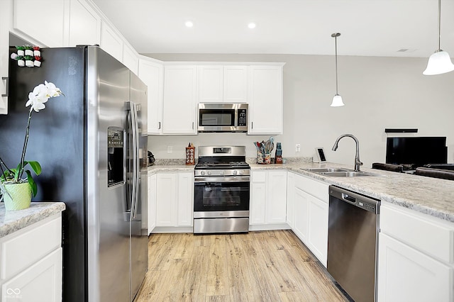3428 Thomas Jefferson St, Westfield, IN 46074 - kitchen featuring appliances with stainless steel finishes, a sink, light wood-style floors, white cabinetry, and recessed lighting