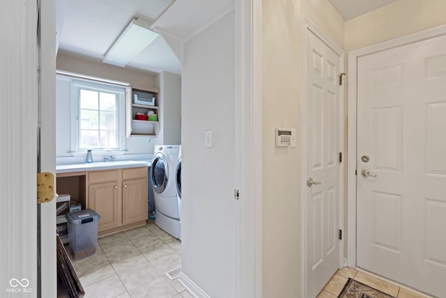 9175 Lakewind Dr, Indianapolis, IN 46256 - laundry room featuring cabinet space, light tile patterned flooring, and washer and dryer