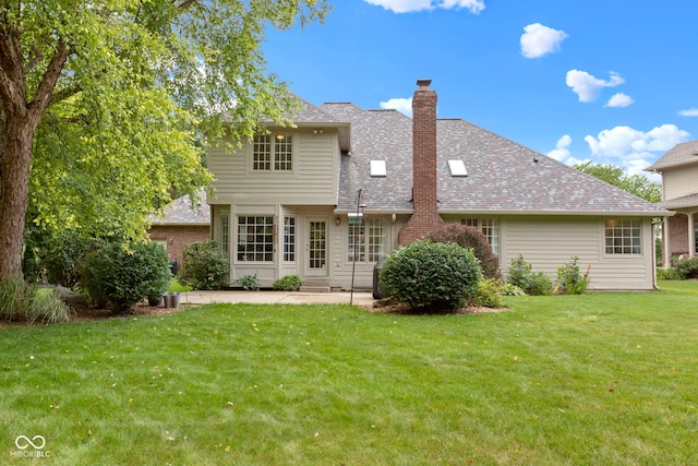 9175 Lakewind Dr, Indianapolis, IN 46256 - rear view of property featuring a chimney, a yard, a patio, and roof with shingles