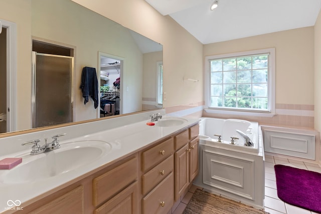9175 Lakewind Dr, Indianapolis, IN 46256 - bathroom with a stall shower, vaulted ceiling, double vanity, a garden tub, and a walk in closet