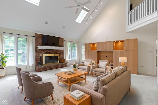 9175 Lakewind Dr, Indianapolis, IN 46256 - living room featuring a skylight, light colored carpet, high vaulted ceiling, rail lighting, and ceiling fan