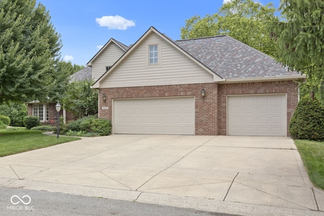 9175 Lakewind Dr, Indianapolis, IN 46256 - traditional home featuring concrete driveway, brick siding, and a garage