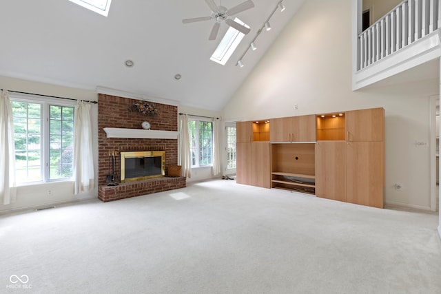9175 Lakewind Dr, Indianapolis, IN 46256 - unfurnished living room featuring a skylight, high vaulted ceiling, carpet floors, and plenty of natural light