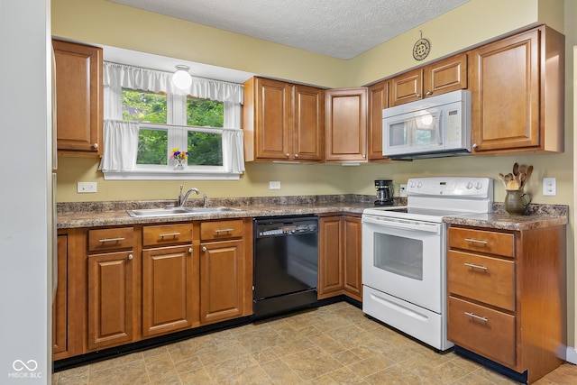 2233 Washington St, Columbus, IN 47201 - kitchen featuring white appliances, a sink, brown cabinetry, and a textured ceiling