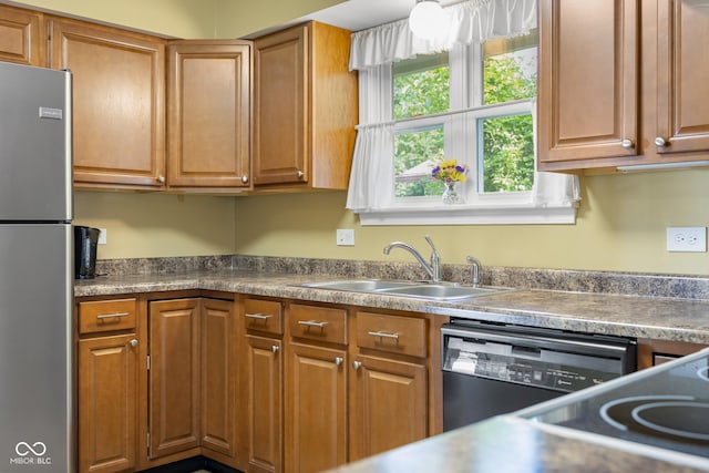 2233 Washington St, Columbus, IN 47201 - kitchen with freestanding refrigerator, a sink, black dishwasher, and brown cabinets