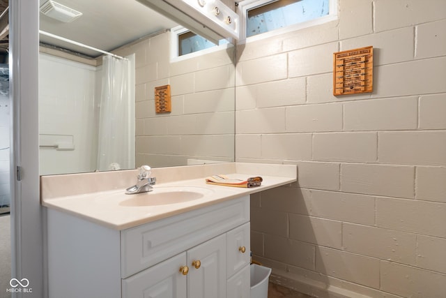 2233 Washington St, Columbus, IN 47201 - full bathroom featuring vanity, concrete block wall, and a shower with curtain