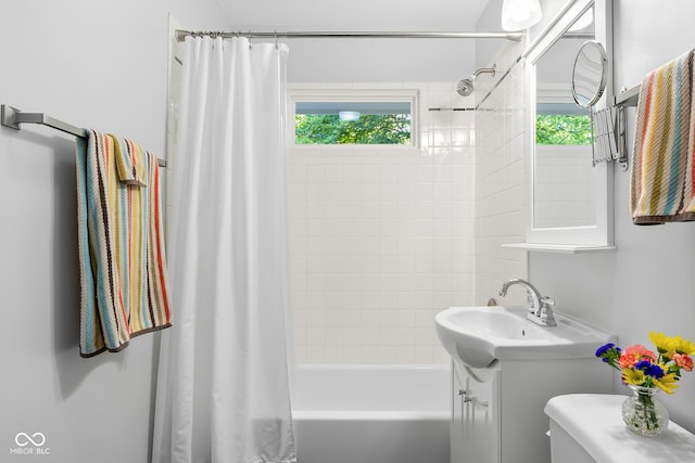 2233 Washington St, Columbus, IN 47201 - full bathroom featuring vanity, shower / tub combo, plenty of natural light, and toilet