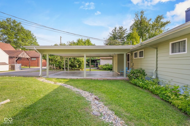 2233 Washington St, Columbus, IN 47201 - view of grassy yard featuring a carport