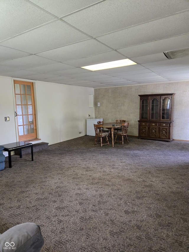 104 Meadow Ln, North Vernon, IN 47265 - carpeted dining area with a drop ceiling and brick wall