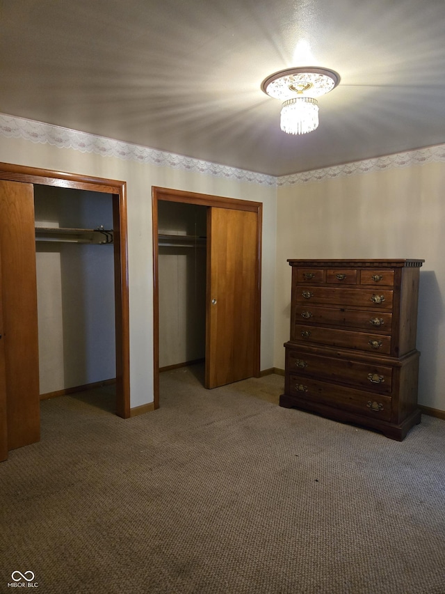 104 Meadow Ln, North Vernon, IN 47265 - carpeted bedroom featuring two closets and baseboards