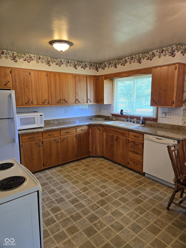 104 Meadow Ln, North Vernon, IN 47265 - kitchen with white appliances, a sink, dark floors, brown cabinetry, and backsplash