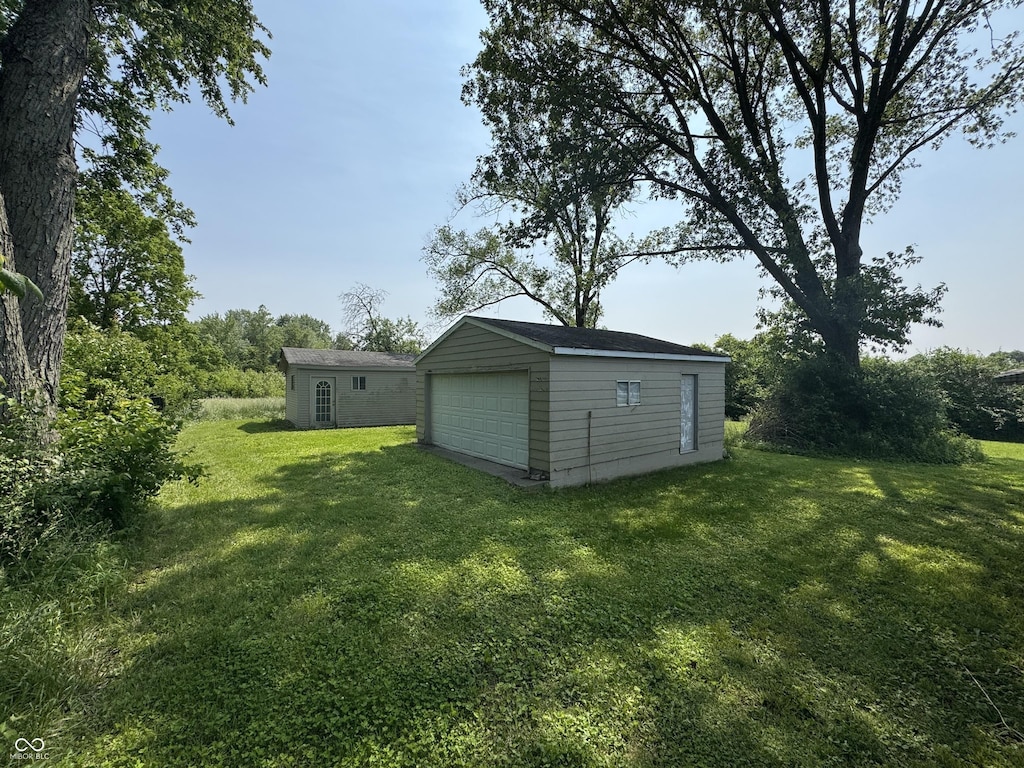 5159 E Edgewood Ave, Indianapolis, IN 46237 - view of grassy yard featuring a garage and an outdoor structure