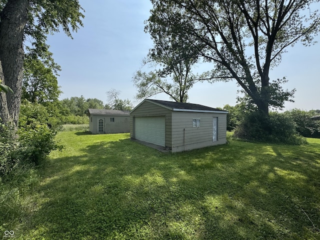 5159 E Edgewood Ave, Indianapolis, IN 46237 - view of grassy yard featuring a garage and an outdoor structure