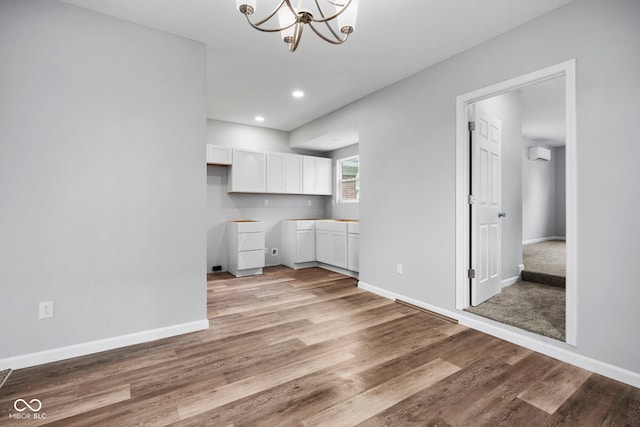 110 E Mcdonald St, Brazil, IN 47834 - kitchen featuring white cabinets, a chandelier, light wood-type flooring, baseboards, and recessed lighting