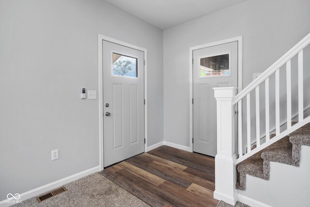 110 E Mcdonald St, Brazil, IN 47834 - foyer featuring stairway, baseboards, and dark wood-style flooring