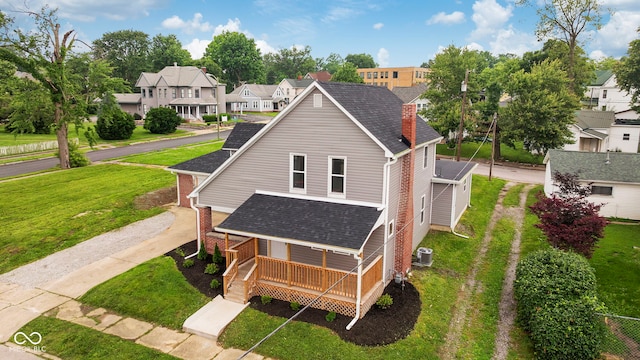 110 E Mcdonald St, Brazil, IN 47834 - view of front of home featuring a porch, a residential view, roof with shingles, and a front yard