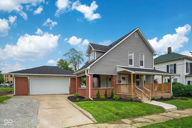 110 E Mcdonald St, Brazil, IN 47834 - view of front of home with brick siding, covered porch, a front yard, and roof with shingles