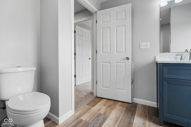 110 E Mcdonald St, Brazil, IN 47834 - bathroom with vanity, toilet, wood finished floors, and baseboards