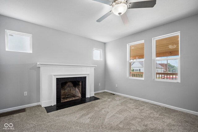 110 E Mcdonald St, Brazil, IN 47834 - unfurnished living room with carpet, a brick fireplace, healthy amount of natural light, and baseboards