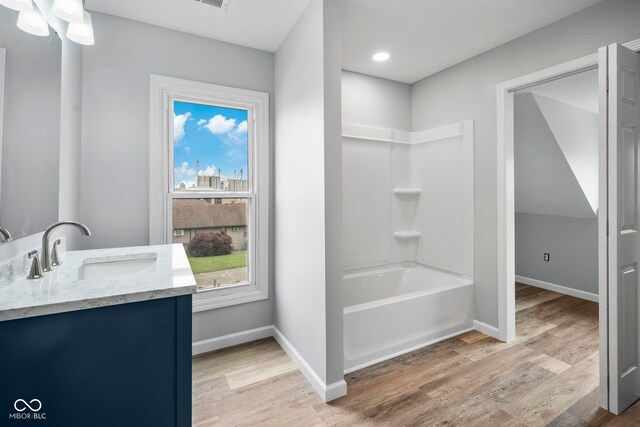 110 E Mcdonald St, Brazil, IN 47834 - bathroom featuring vanity, wood finished floors, bathing tub / shower combination, baseboards, and recessed lighting