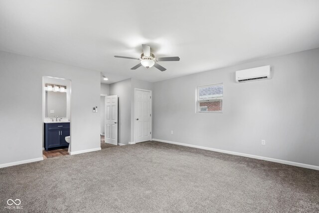 110 E Mcdonald St, Brazil, IN 47834 - unfurnished bedroom featuring a wall mounted air conditioner, dark carpet, baseboards, a sink, and ensuite bathroom