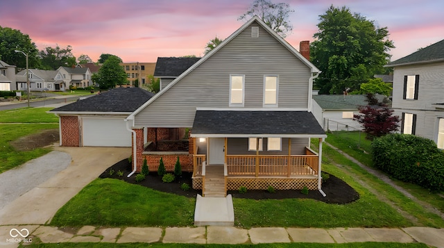 110 E Mcdonald St, Brazil, IN 47834 - view of front of house with covered porch, concrete driveway, a yard, and brick siding