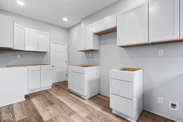 110 E Mcdonald St, Brazil, IN 47834 - kitchen with light wood-type flooring, white cabinets, and recessed lighting