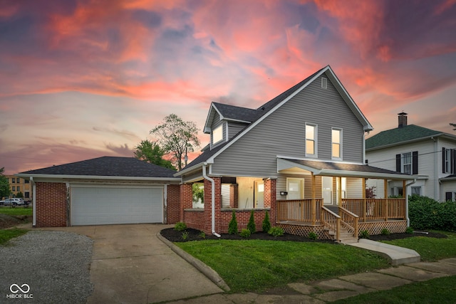 110 E Mcdonald St, Brazil, IN 47834 - view of front of home with a porch, brick siding, a front lawn, and a garage
