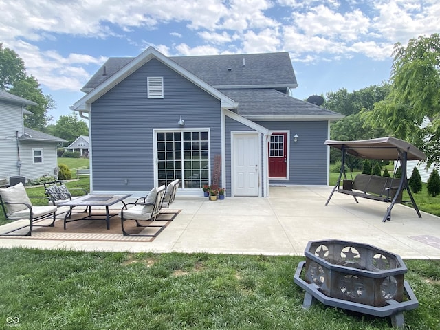 725 E Washington St, Greencastle, IN 46135 - back of house featuring a patio area, a lawn, a shingled roof, and a fire pit