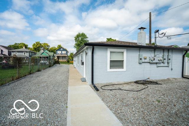 1631 Columbia Ave, Indianapolis, IN 46202 - view of property exterior with concrete block siding and a chimney