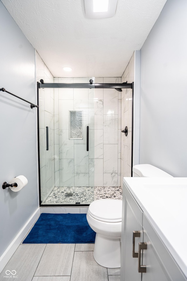 1631 Columbia Ave, Indianapolis, IN 46202 - full bath featuring toilet, vanity, a stall shower, baseboards, and a textured ceiling