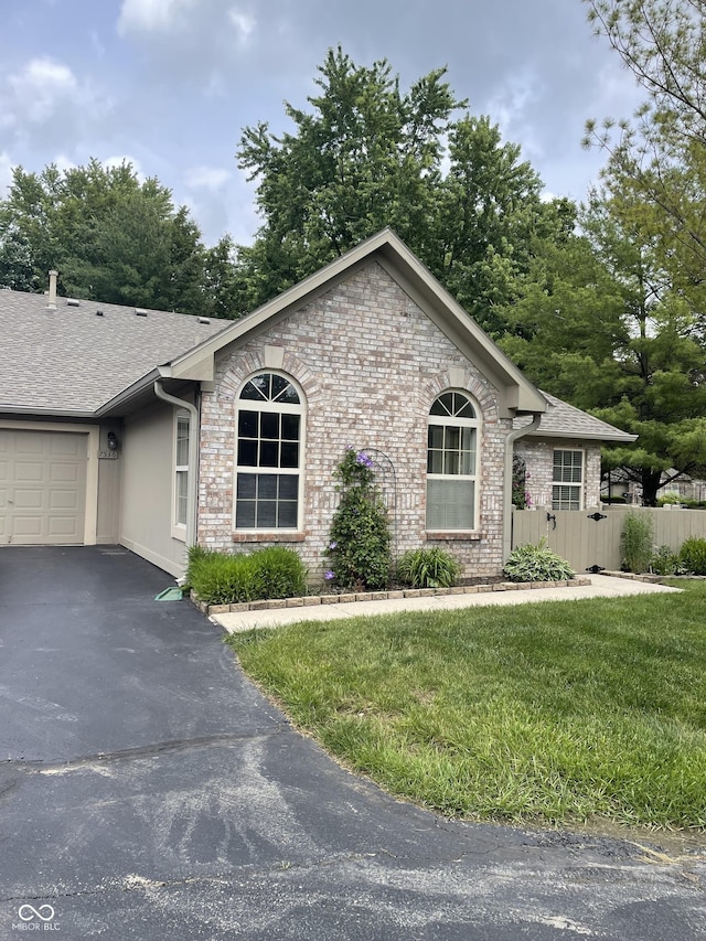 7536 Briarstone Dr, Indianapolis, IN 46227 - single story home with brick siding, asphalt driveway, a garage, and a shingled roof