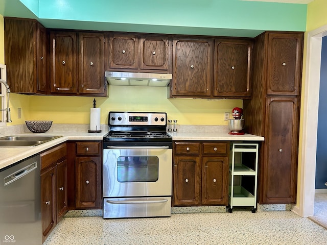 5491 Vin Rose Ln, Lawrence, IN 46226 - kitchen featuring appliances with stainless steel finishes, under cabinet range hood, a sink, light countertops, and dark brown cabinets