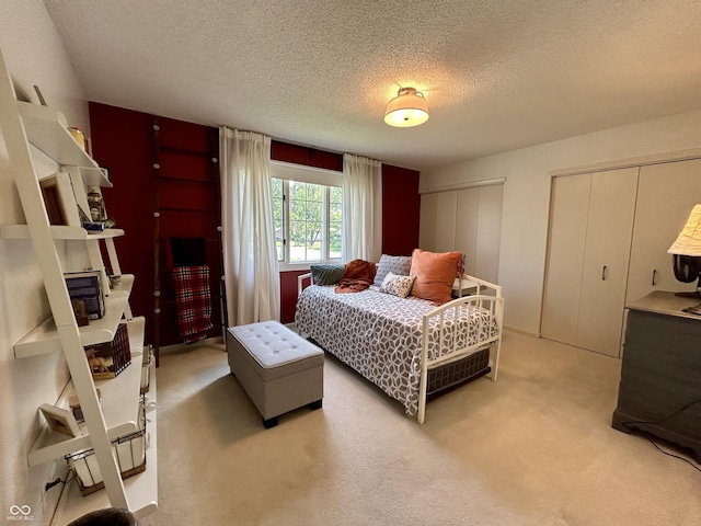 5491 Vin Rose Ln, Lawrence, IN 46226 - bedroom with multiple closets, light colored carpet, and a textured ceiling