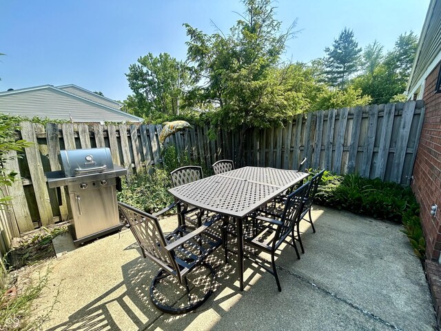 5491 Vin Rose Ln, Lawrence, IN 46226 - fenced backyard featuring a patio, grilling area, and outdoor dining space