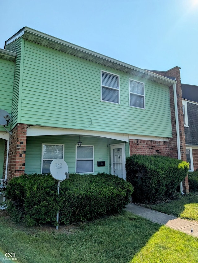 6322 Commons Dr, Indianapolis, IN 46254 - townhome / multi-family property featuring a front yard and brick siding