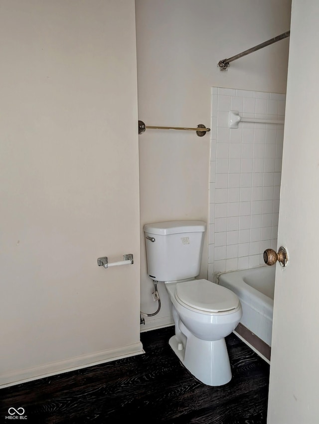6322 Commons Dr, Indianapolis, IN 46254 - bathroom with toilet, wood finished floors, baseboards, and  shower combination