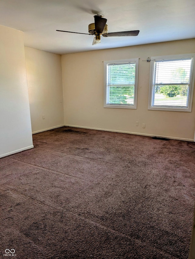 6322 Commons Dr, Indianapolis, IN 46254 - unfurnished room featuring plenty of natural light, carpet floors, a ceiling fan, and baseboards