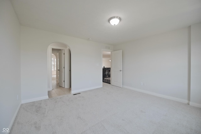 15201 Slateford Rd, Noblesville, IN 46062 - unfurnished bedroom featuring arched walkways, light carpet, and baseboards